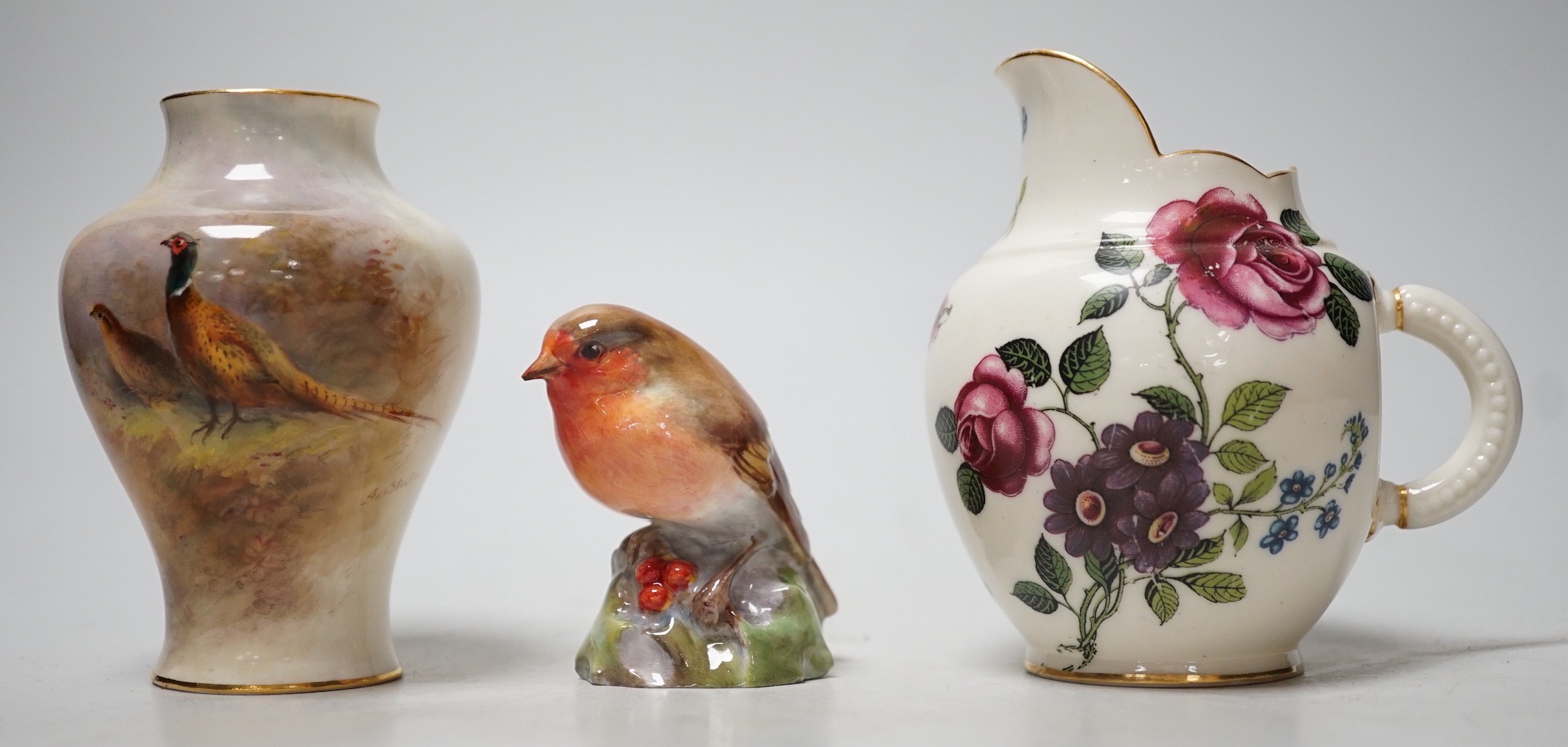 A Royal Worcester James Stinton vase with pheasant decoration, together with a Royal Worcester jug and a Royal Worcester robin figure. Tallest 10cm